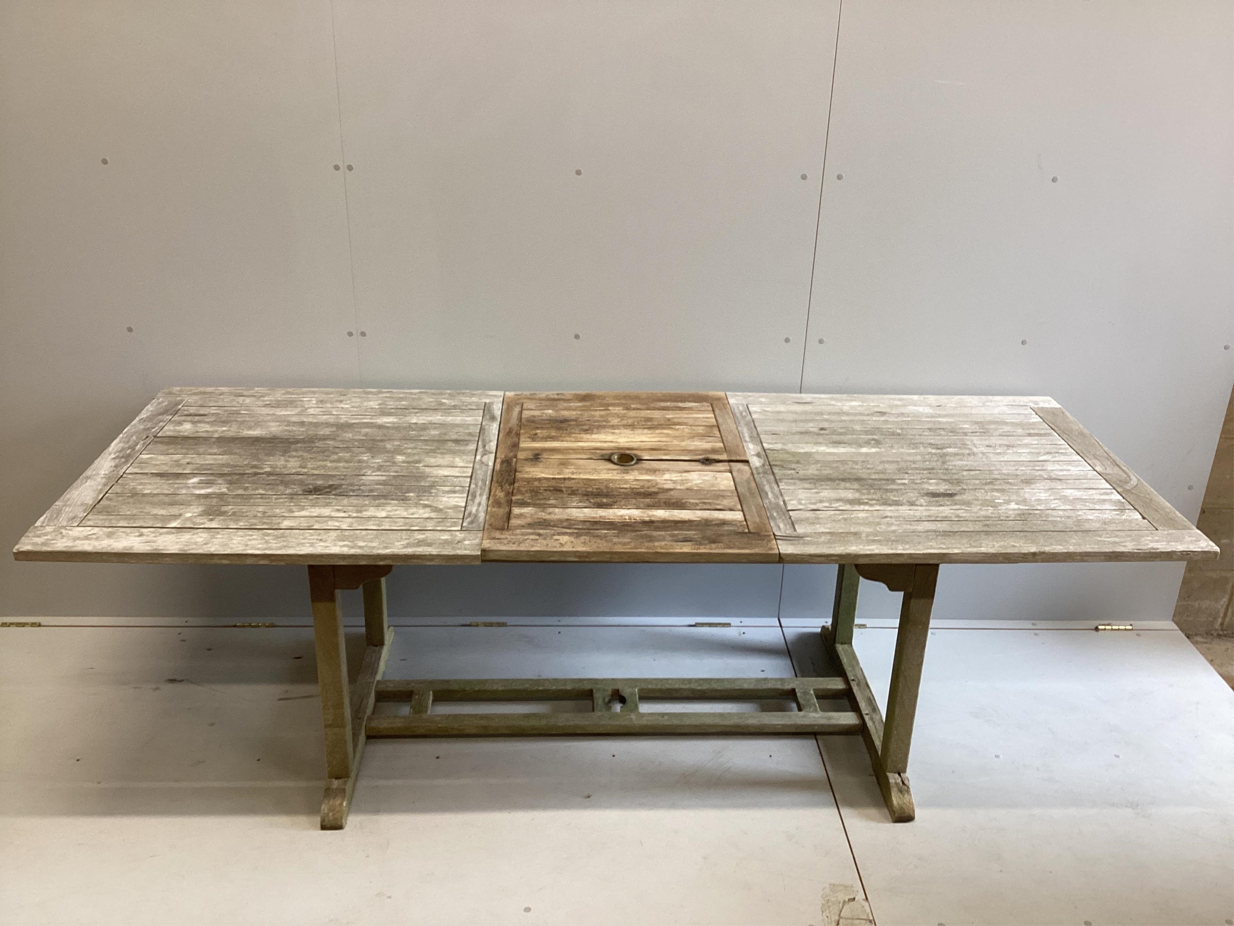 A weathered teak rectangular extending garden table, width 240cm extended, width 89cm, height 75cm. Condition